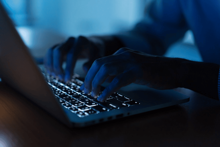 close up of hands typing at keyboard
