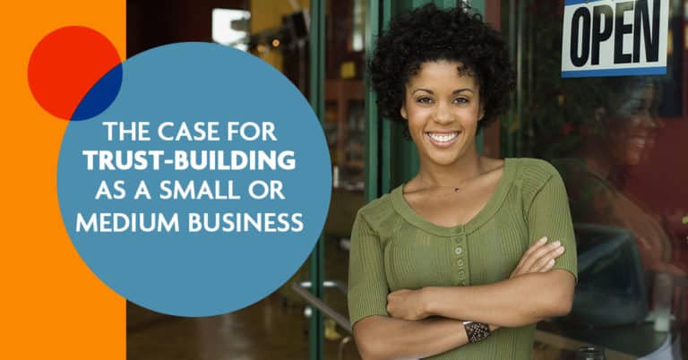 smiling small business woman in front of open sign