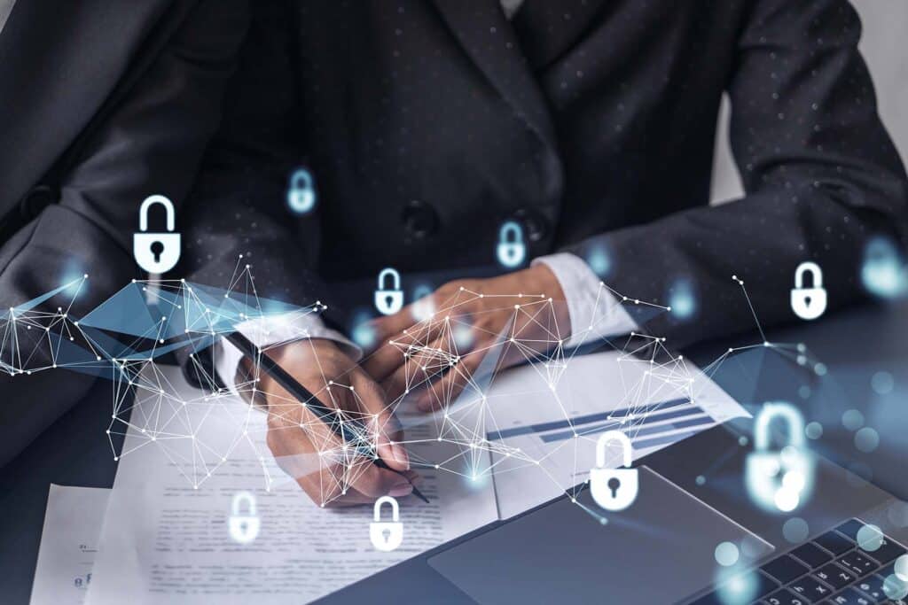 businesswomen with padlock hologram icons leaning over a table with documents